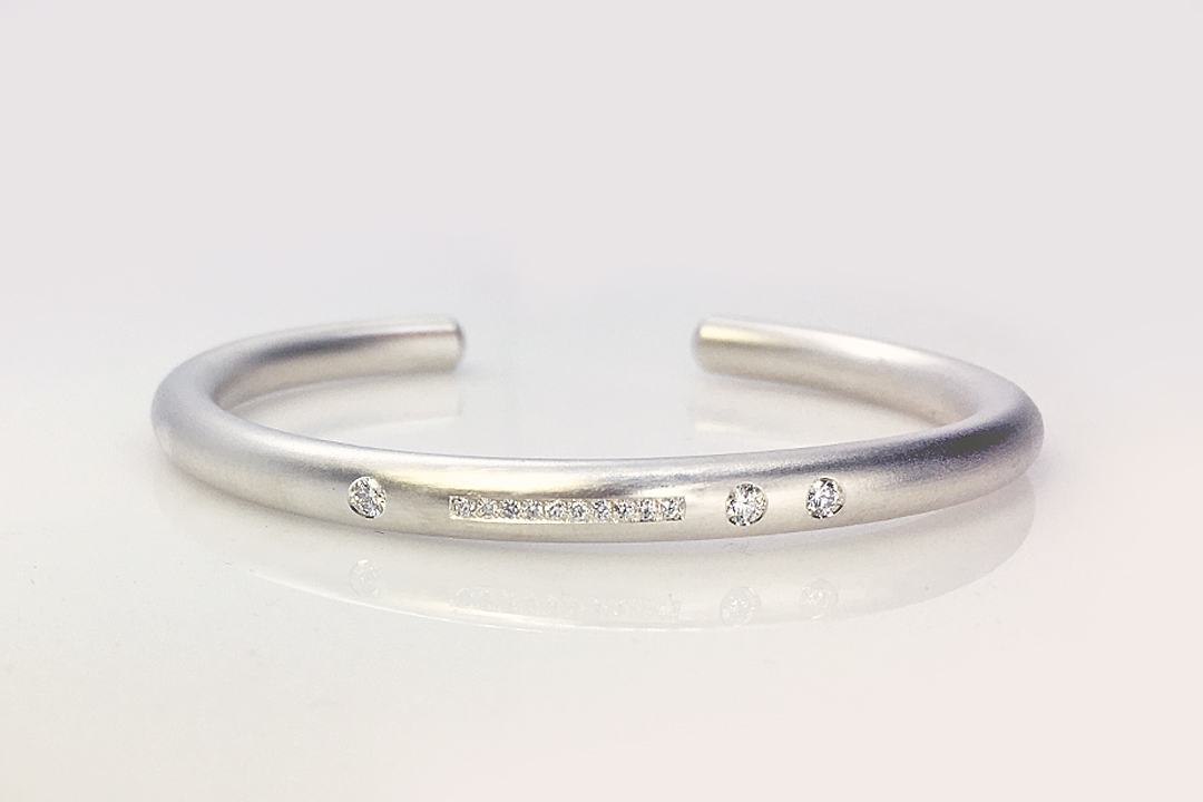 Finding a new life for the stones that were once in a ring, our client chose this Repurposed Diamond Silver Armband based on a similar armband design we created.